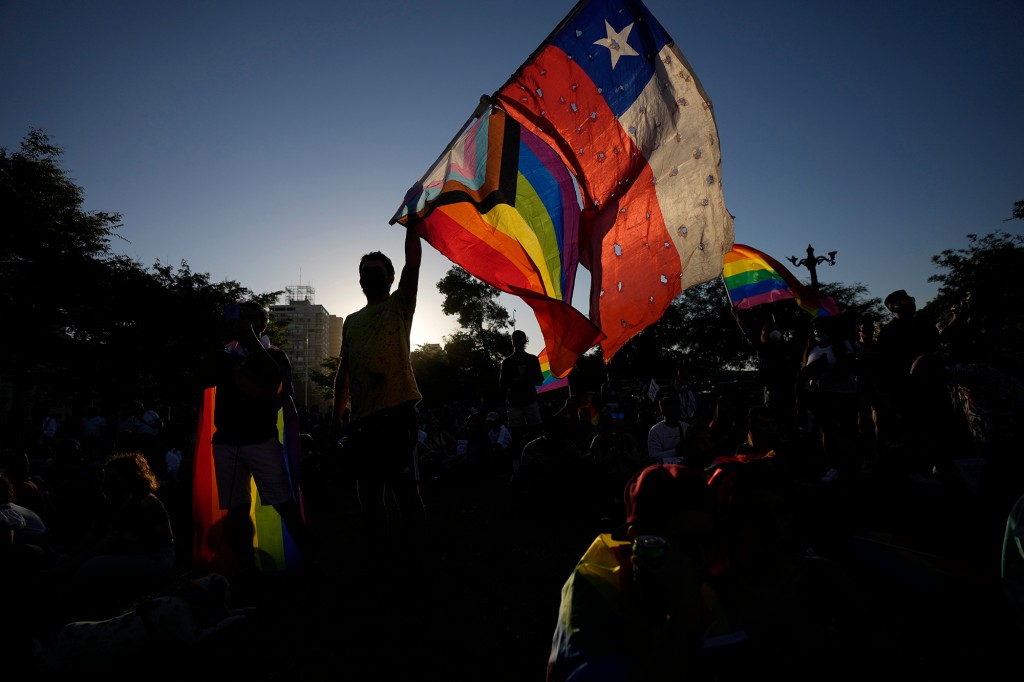 Members of the Movement for Homosexual Integration and Liberation celebrate after lawmakers approved legislation legalizing marriage and adoption by same-sex couples, in Santiago, Chile, Tuesday, Dec. 7, 2021. 