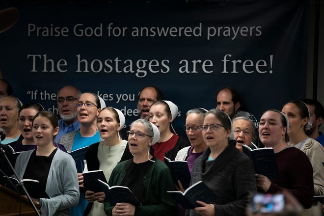 Staff members at Christian Aid Ministries sing at the end of a press conference at Christian Aid Ministries, in Berlin, Ohio, Monday, December 20, 2021. All 17 staff members of Christian Aid Ministries who were held hostage in Haiti by the 400 Mawozo gang, have returned home.